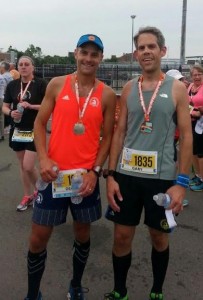 Dean Mercer, left, and Gary Ogden, pose with their medals after completing the  half marathon on Sunday