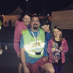 Jesse Davidson celebrates with family after completing the Into the Night 5 k  Friday.