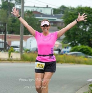 Sherri Colwell-McCavour celebrates as she completes the half marathon on Sunday.