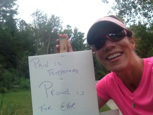 Sherri Colwell-McCavour poses with a motivational sign during her run Sunday.