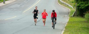 Price Todd Price, left, runs toward the finish of the marathon Sunday with training partner  Shelley Doucet, centre, and his sister, on the bike, Tracey Price-Emerson.