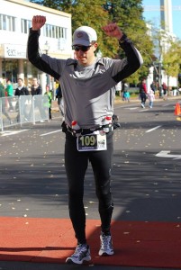 Const. Doug Larche celebrates after completing the Legs for Literacy full marathon in Moncton.